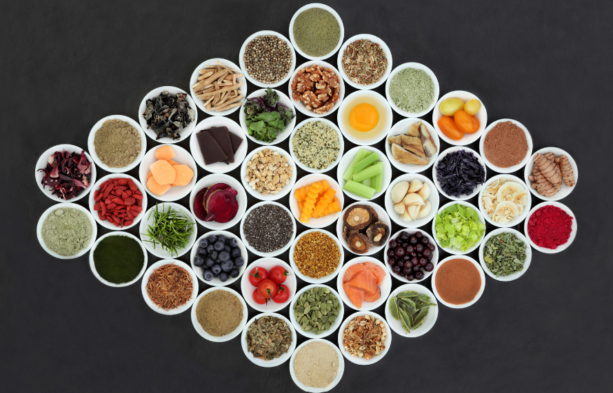 A collection of organised bowls containing 'brain boosting foods' on a black background.