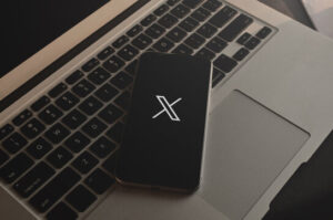 X logo displayed on a mobile phone.