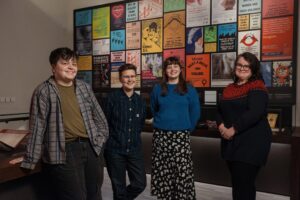 The team behind 'Animated Activism: Women Empowered' standing in front of one of the exhibition pieces.