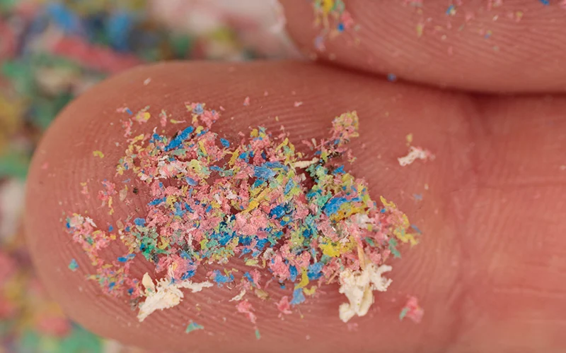 Microplastics on a human finger.